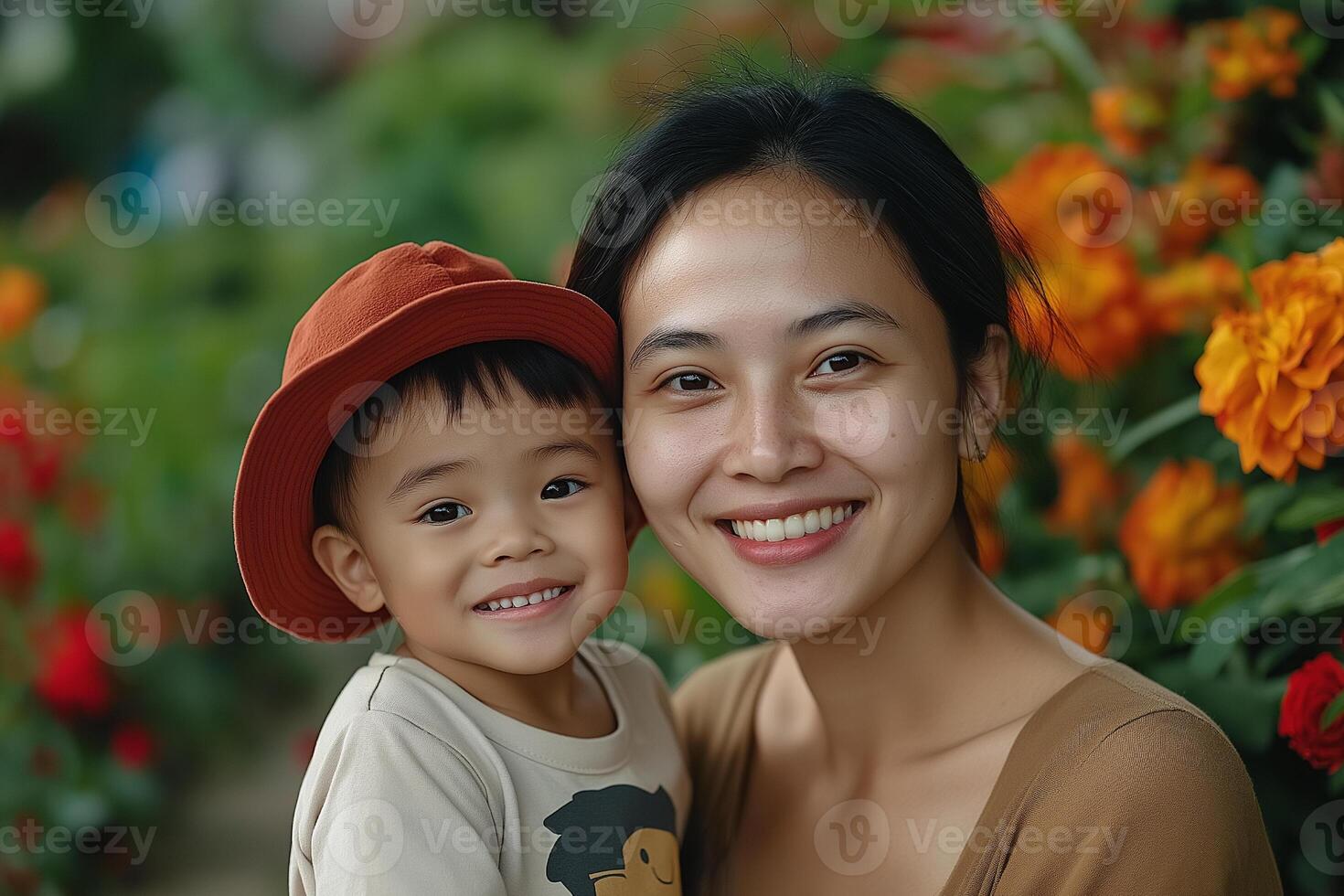 Smiling mother and child in garden with colorful flowers and bright hats. mothers Day photo