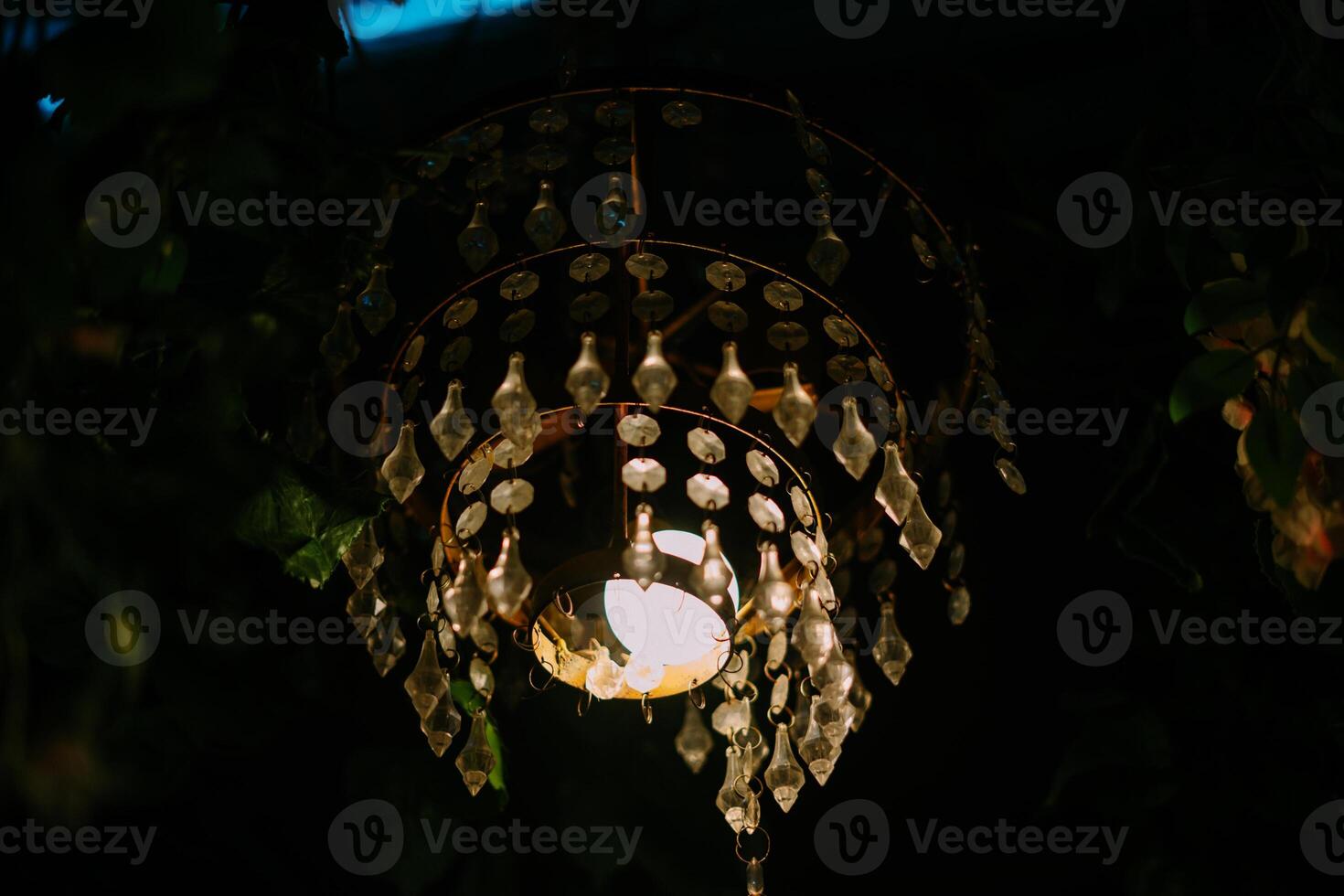 A magnificent crystal chandelier illuminates a high-ceilinged room so nice so photo
