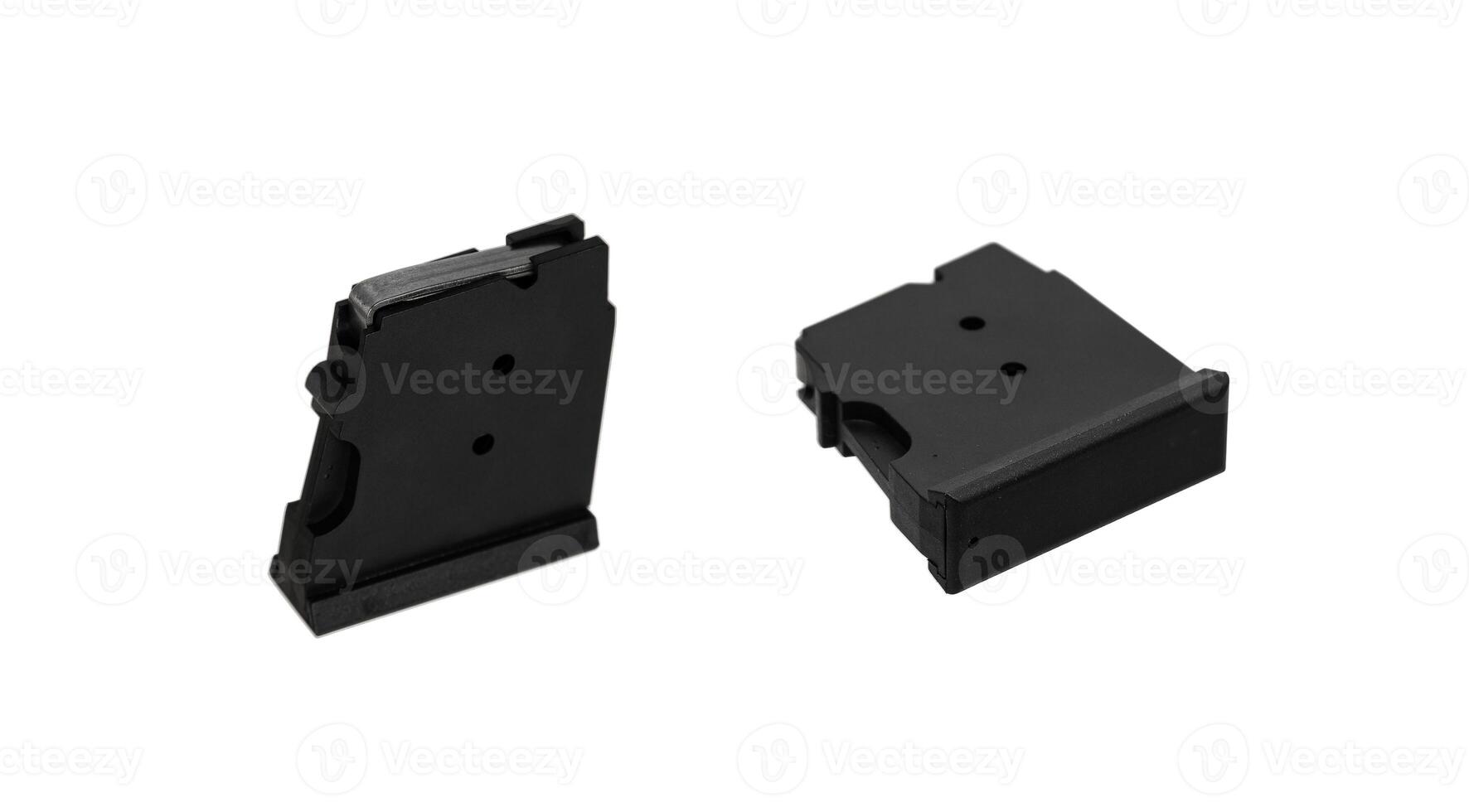 Two black .22lr caliber rifle magazines, one standing upright and the other lying flat, isolated on a white back photo