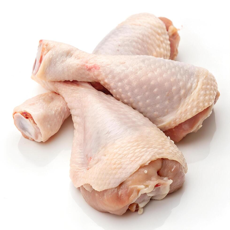 Raw chicken drumsticks, isolated on white background photo