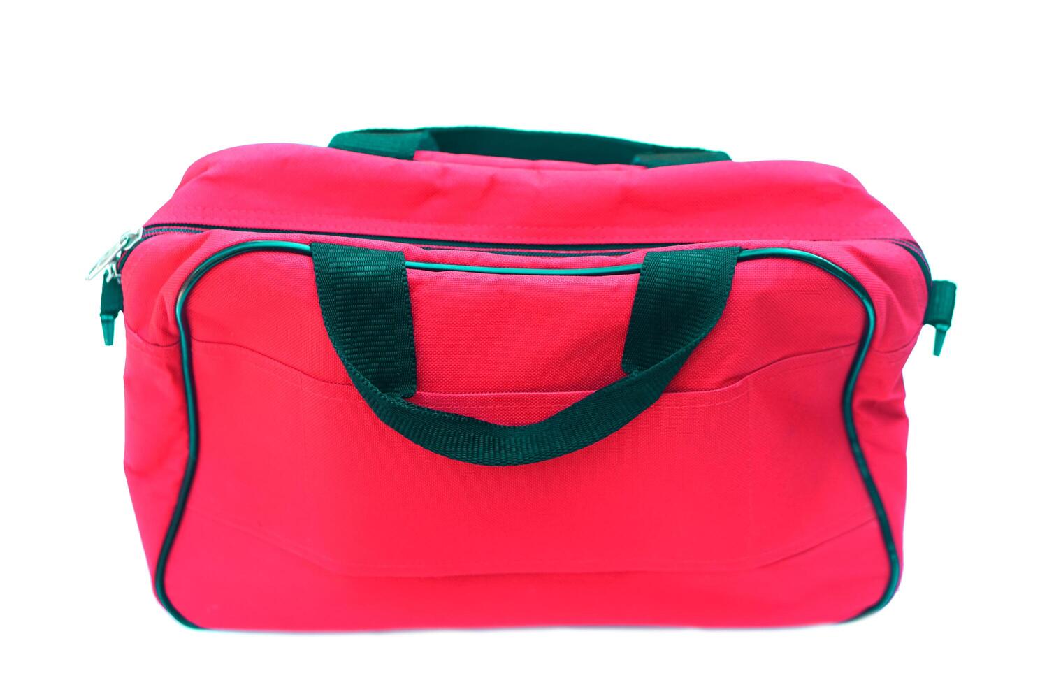 Red bag isolated on white background. Concept, equipment for containing things or cloth when traveling. Baggage or luggage using in daily life. photo