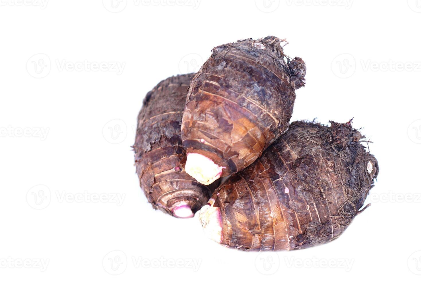 Organic taro roots isolated on white background. Concept, edible plant root that can be cooked for many delicious menu of food and dessert. Agricultural crops. photo