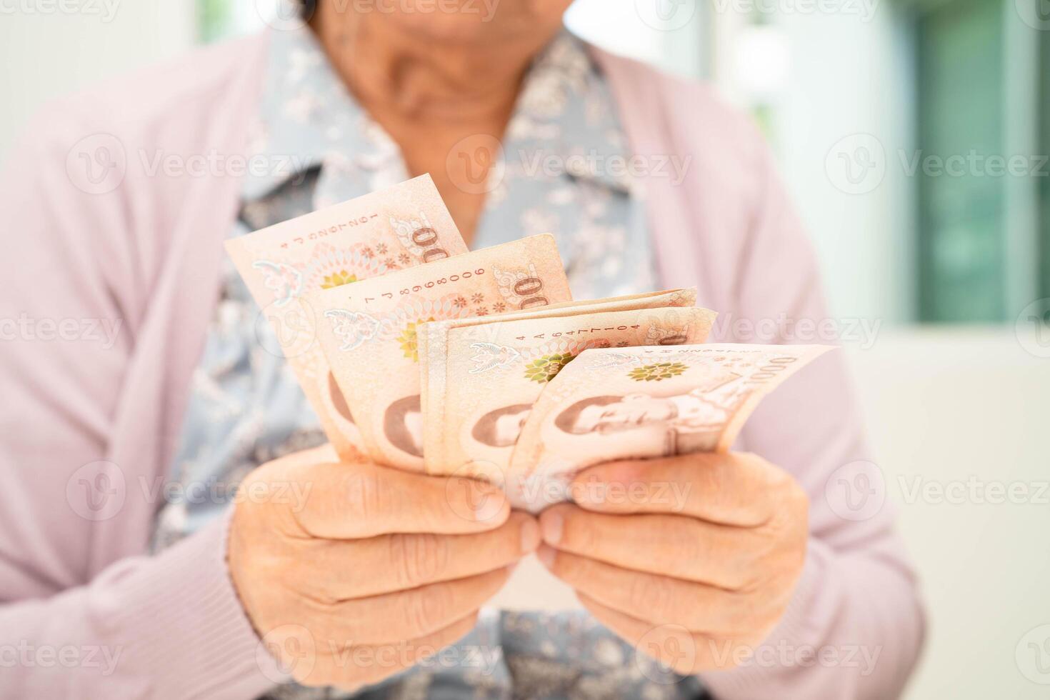 Retired elderly woman counting coins money and worry about monthly expenses and treatment fee photo
