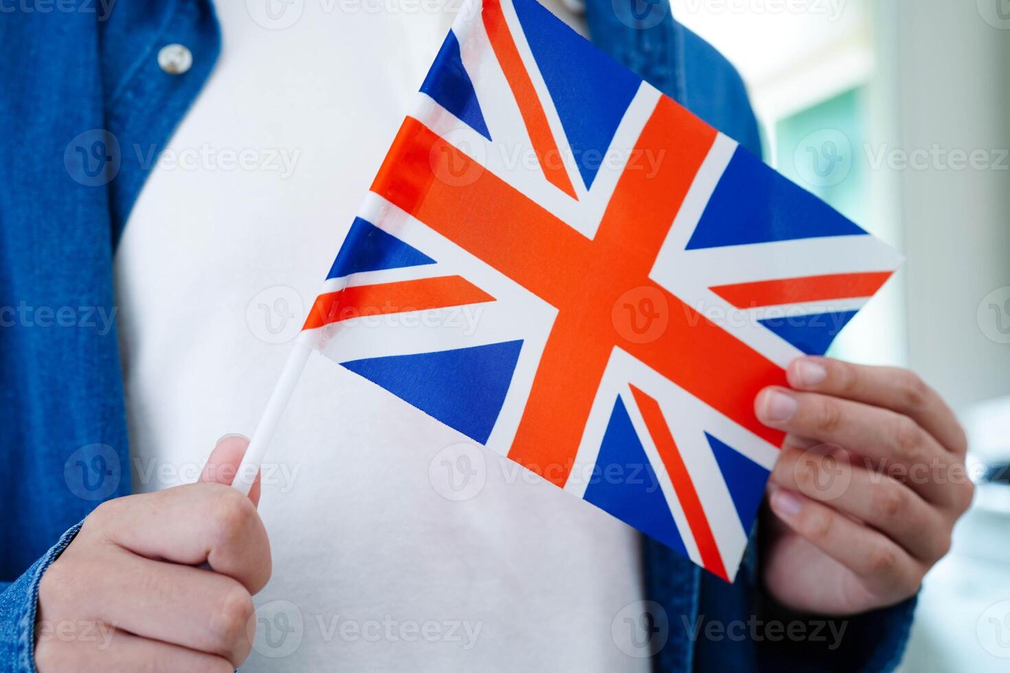 Learn English language, Asian teenage student hold book with flag photo