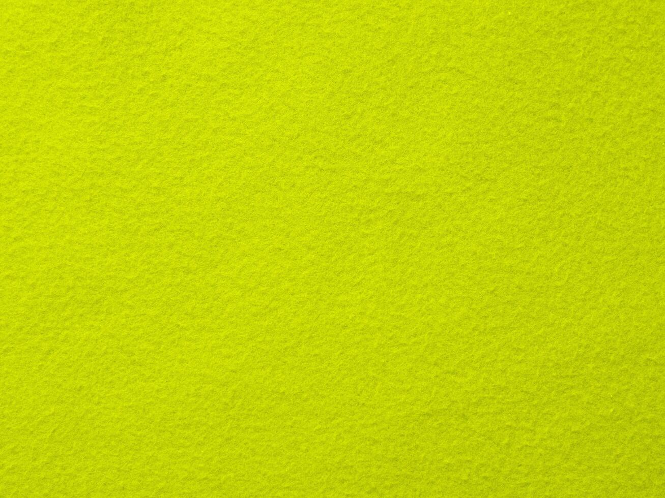 A bright green background with a yellow object in the foreground photo
