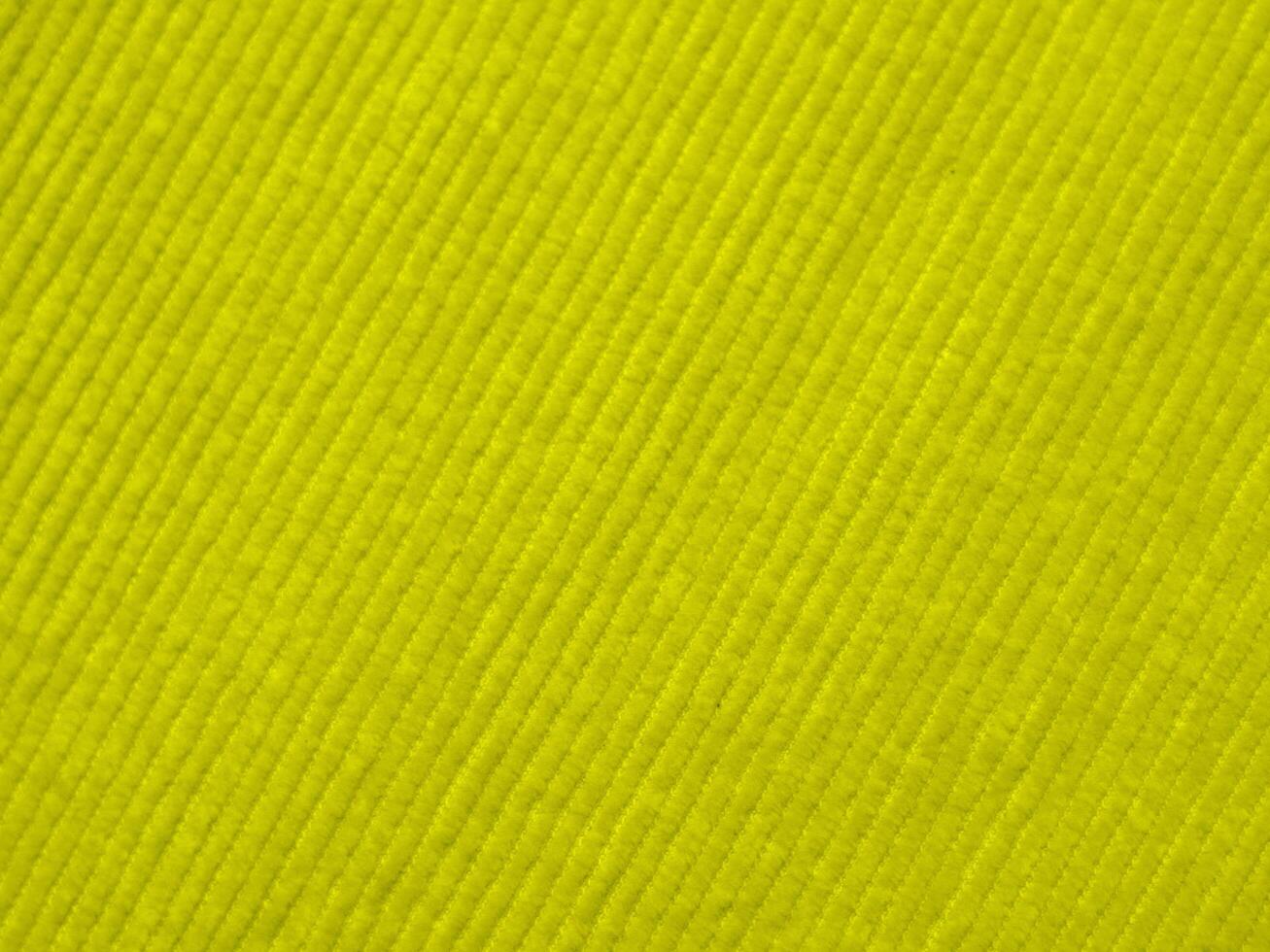 A bright yellow fabric with a striped pattern photo