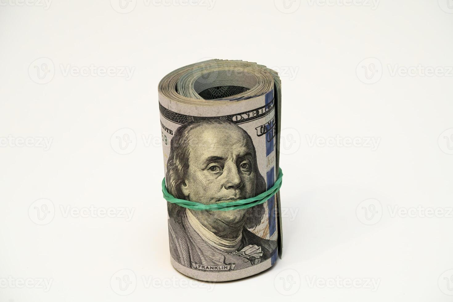 Rolled money banknote secured with a rubber band on a white surface photo