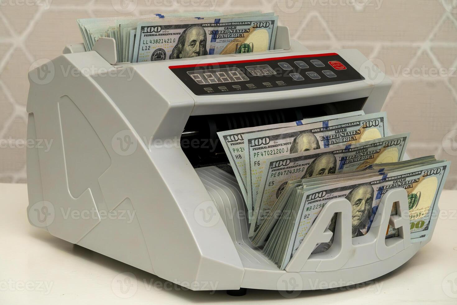 Currency counting machine processing banknotes in a bright setting photo