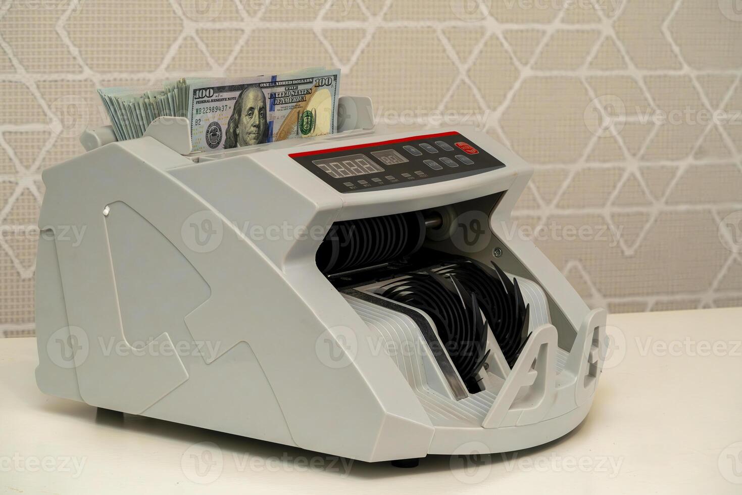 Currency counting machine processing bills in a financial environment photo
