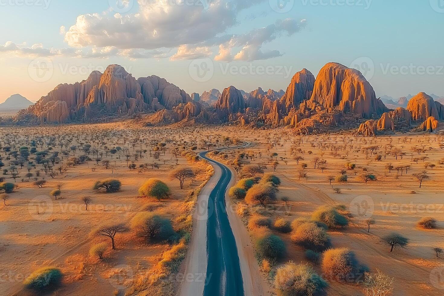 Scenic Desert Road at Sunrise Journey Through Majestic Sandstone Landscape photo