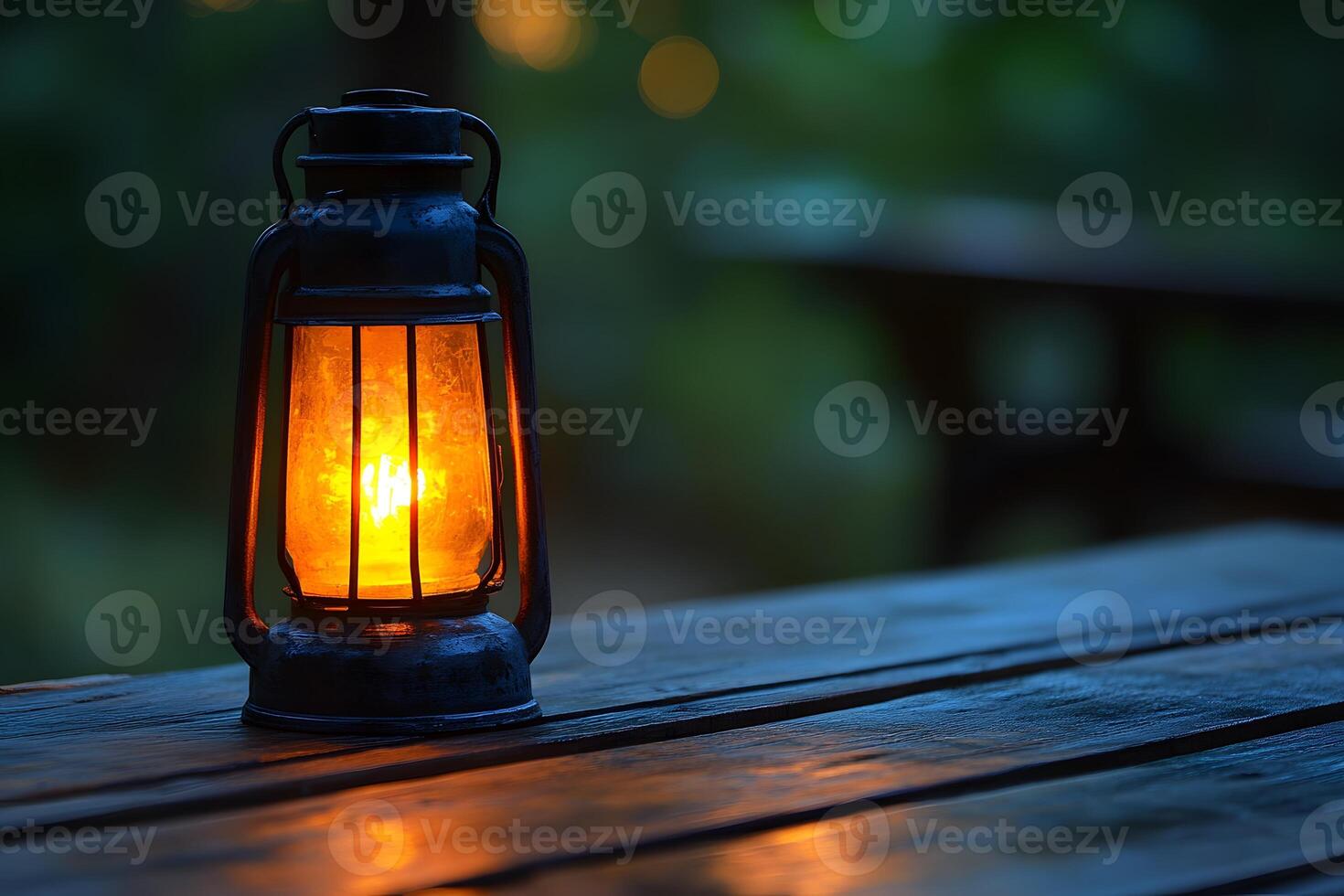 Rustic Lantern Illuminating Wooden Table at Dusk for Cozy Outdoor Setting photo