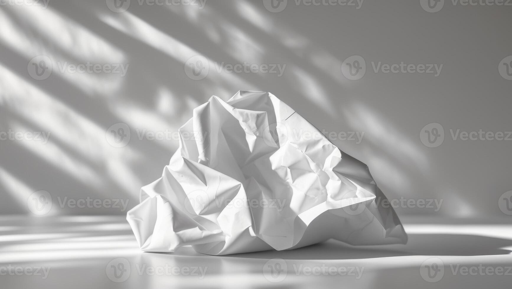 Crumpled white paper with subtle light and shadows photo