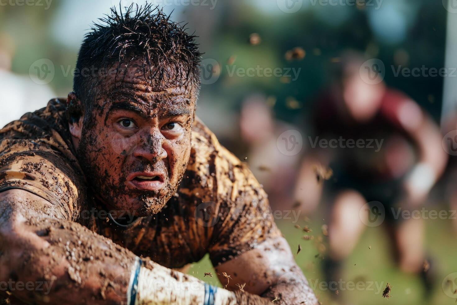 In intense rugby match Hispanic player prosthetic arm tackles opponent as dirt flies on grassy field. determination is evident in player's expression photo