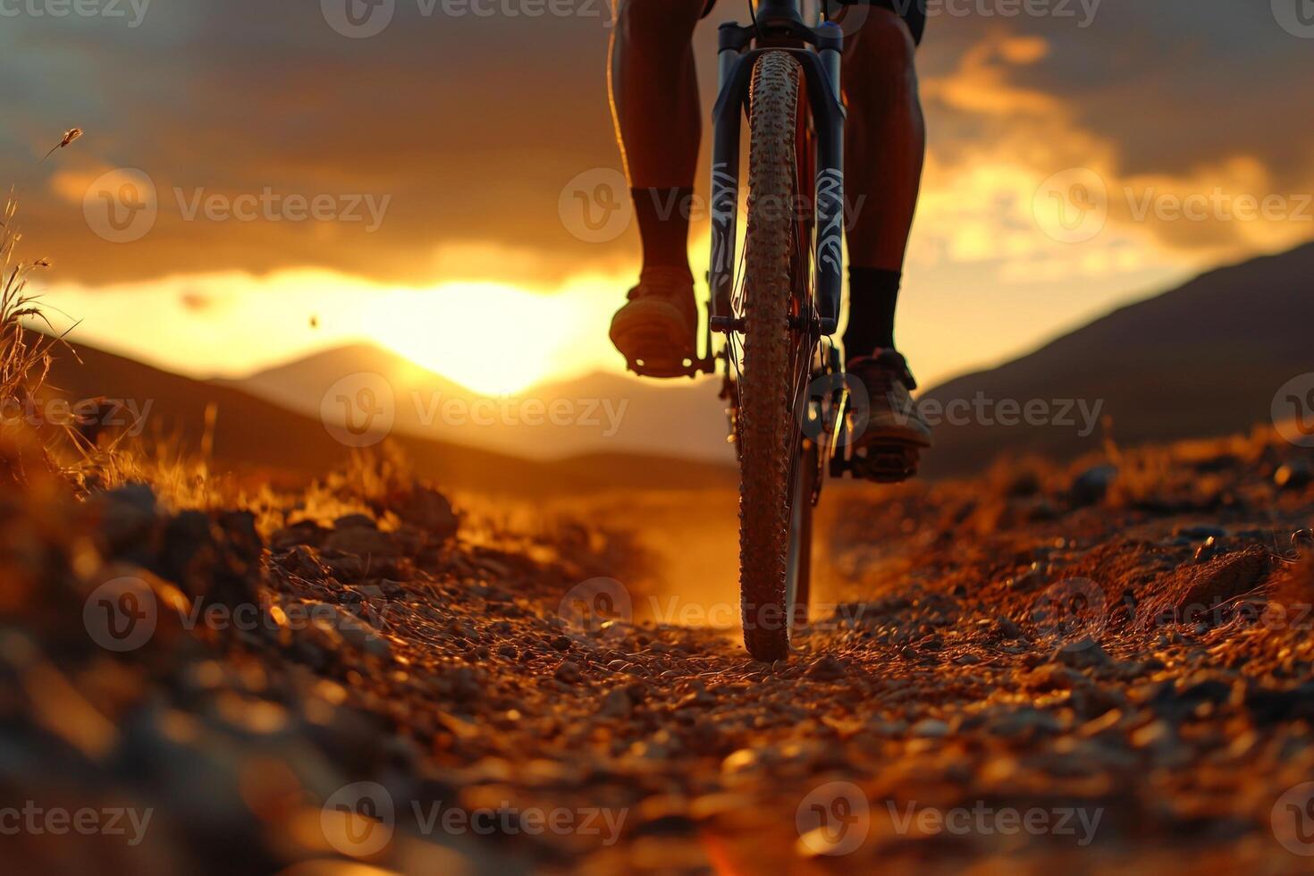 African cyclist prosthetic arm rides through dusty desert trail as sun sets casting golden glow on landscape and creating picturesque atmosphere photo