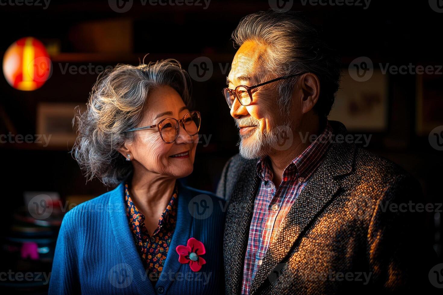 Middle aged Asian couple shares candid moment dancing joyfully in their cozy living room. Soft light pours through window casting warm glow while music records are scattered around photo