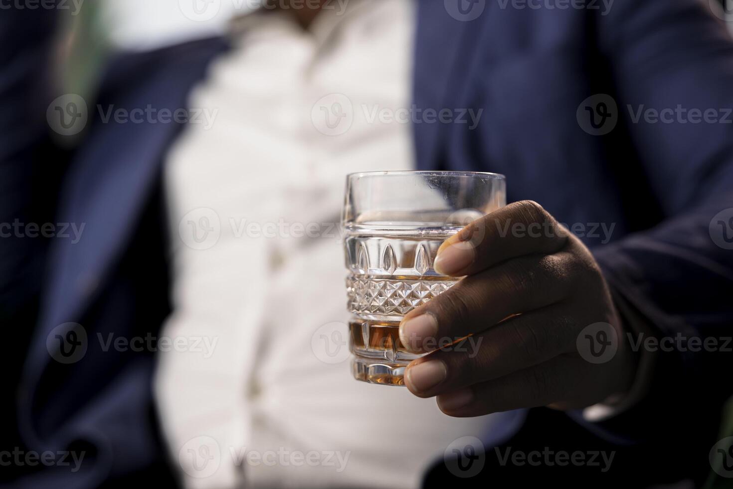 Two partners drinking glass of whiskey in the social club library, discuss career goals and perspectives to double fortune. Upper class elite gentlemen serving scotch and do business. Close up. photo