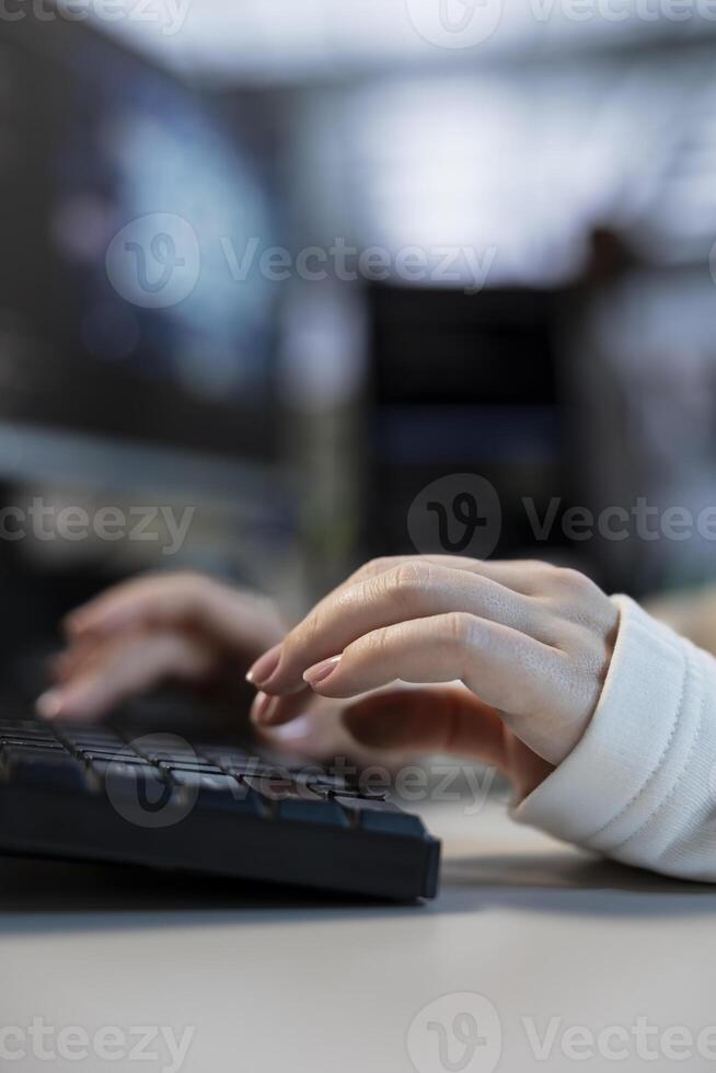 Engineer typing on keyboard in data center coordinating deployment of server architecture, improving data processing speed. Close up of employee in server farm configuring and testing hardware photo