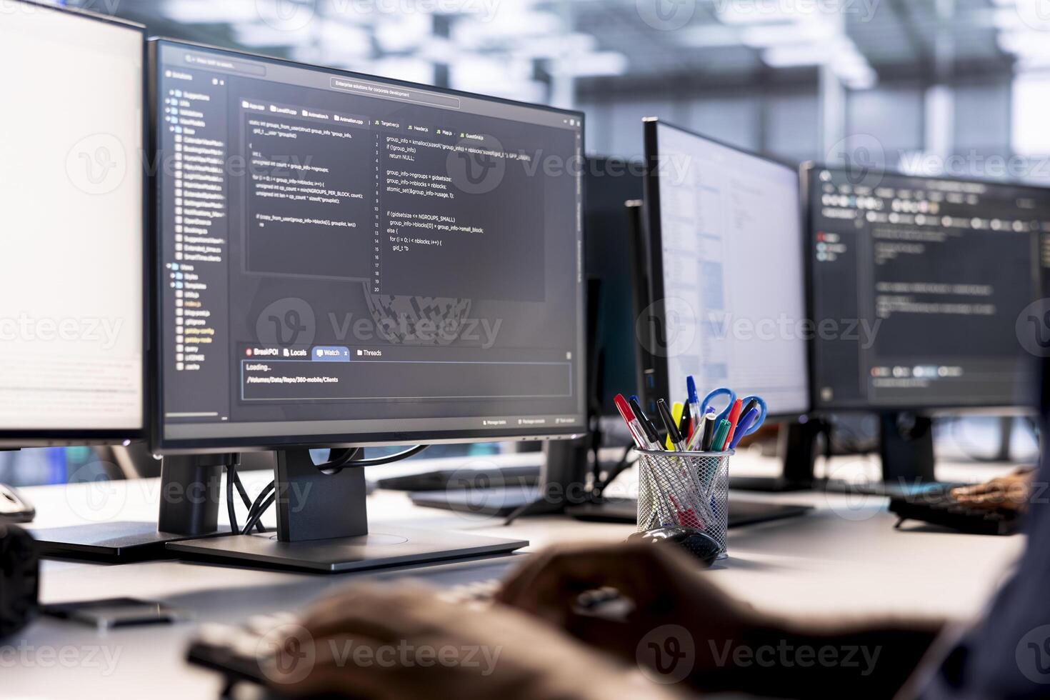 Data center technician using programming languages on PC to construct algorithms and build applications. Close up of server hub IT professional debugging and optimizing code photo