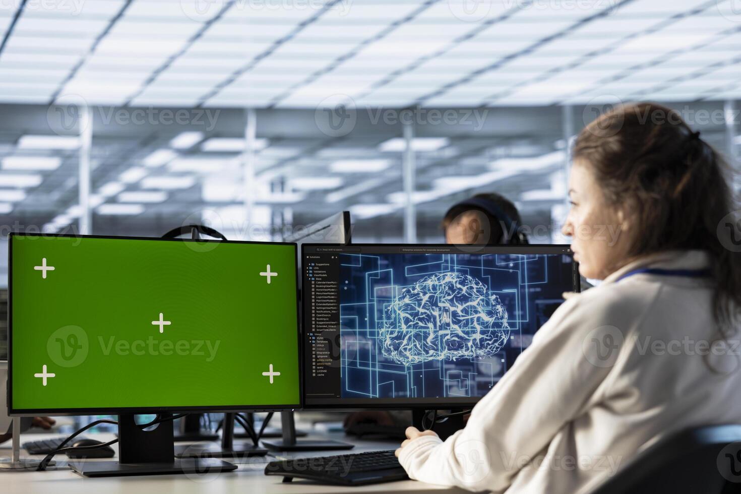 Server hub worker working on green screen computer, using AI to process data. IT programmer at chroma key PC updating servers controlling network resources using artificial intelligence photo