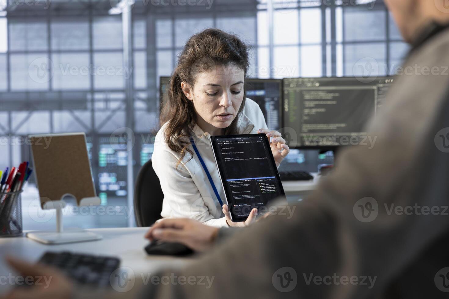 Admin in server hub using tablet, implementing power management solutions to reduce energy consumption. Worker integrating new technologies and systems in data center facility using device photo