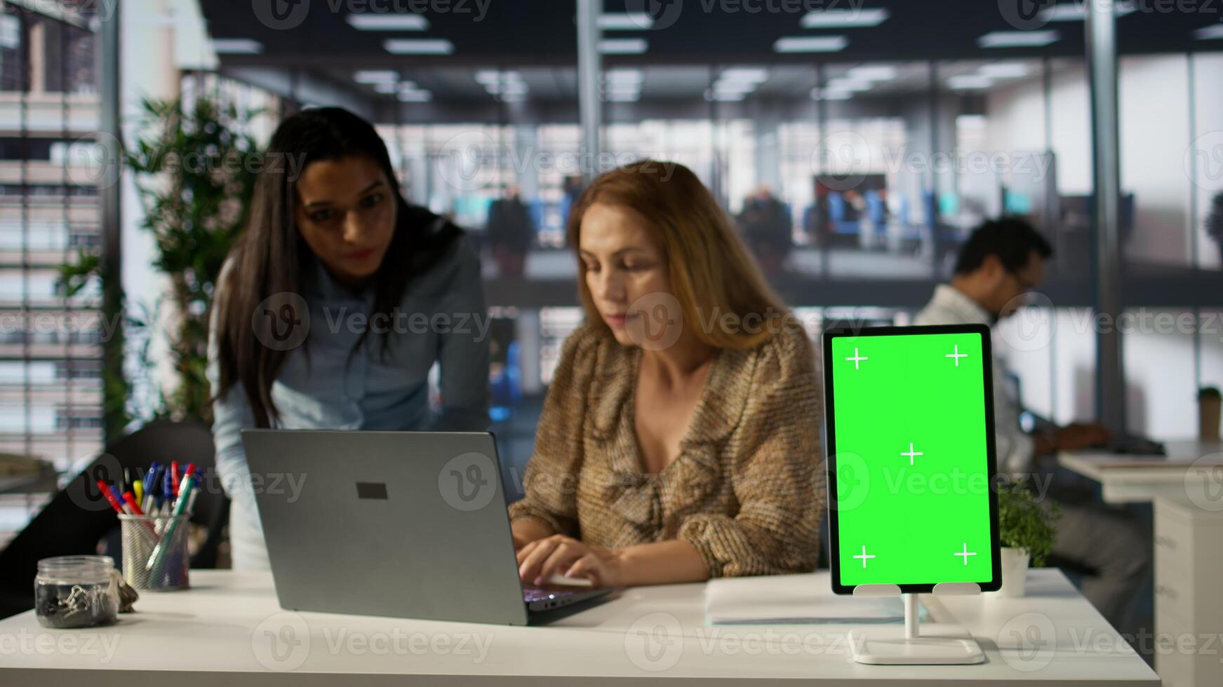 Female CEO engaging in project management using green screen to set goals and objectives, solve problems and track performance metrics of the company. Administrative tasks and decisions. Camera B. photo