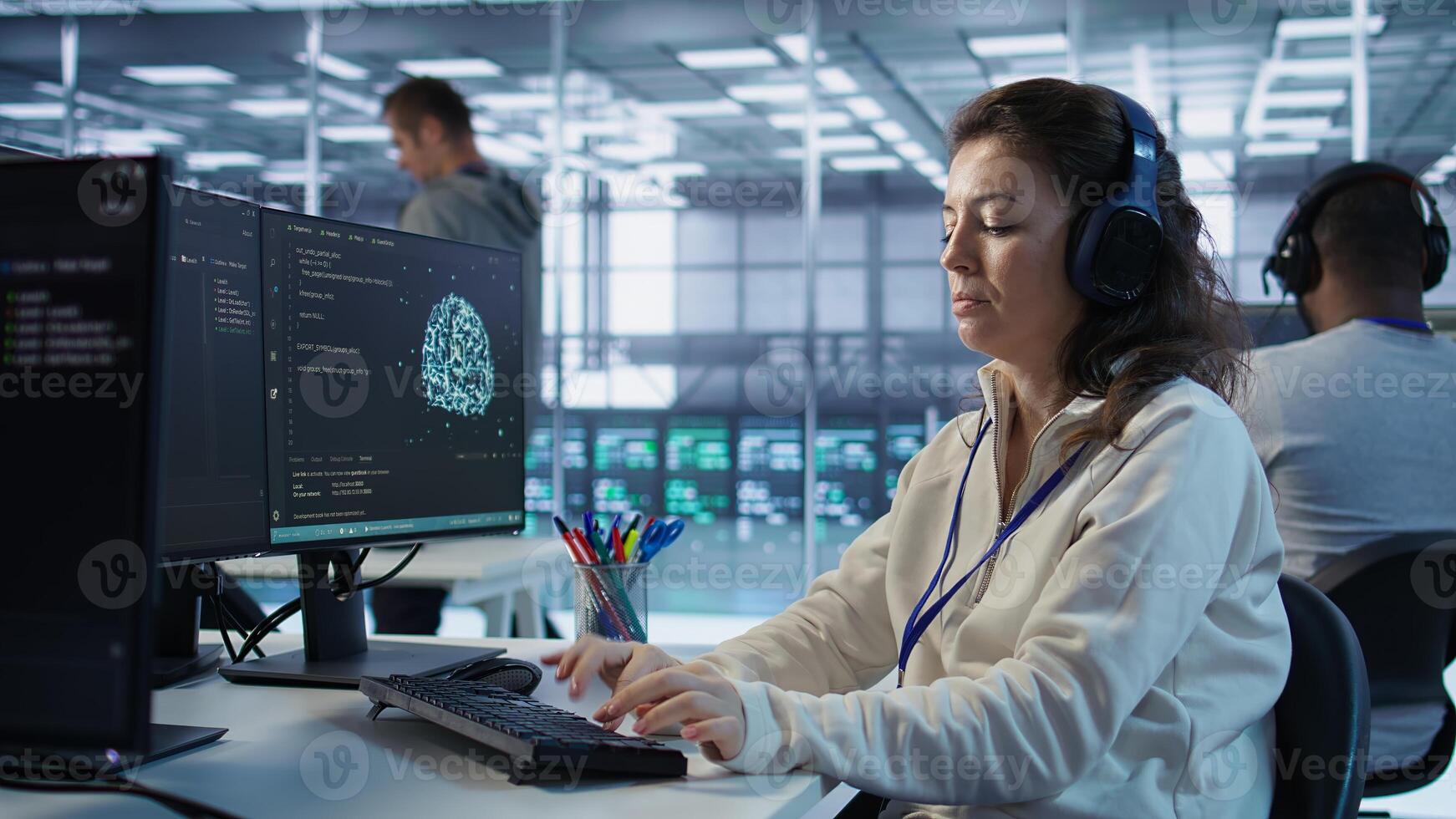Developer listening music while programming in AI data center used for machine learning training. IT specialist wearing headphones running code to upgrade artificial intelligence tech, camera B photo