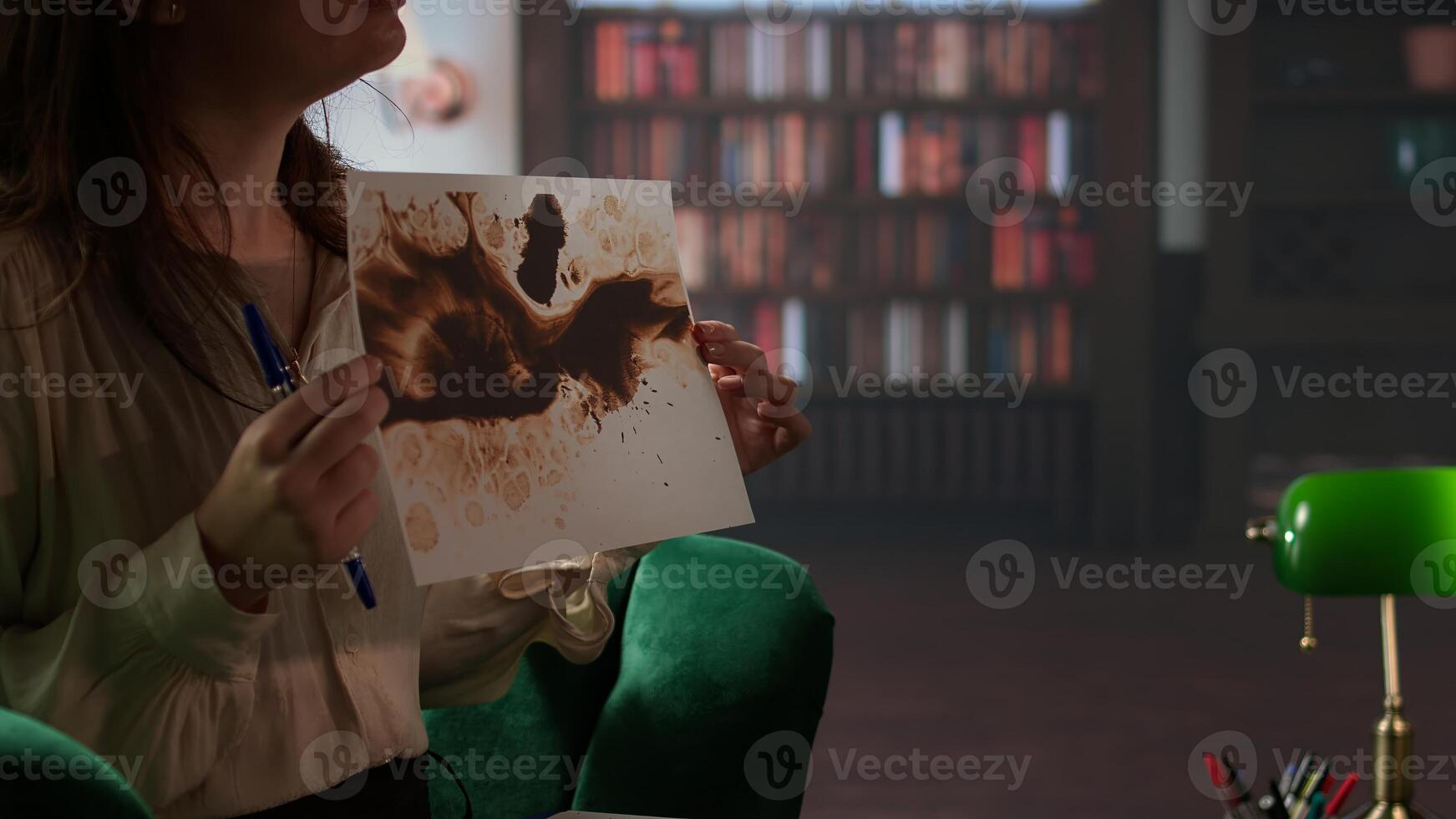 Armed forces veteran in uniform sits with a therapist during counseling, viewing a Rorschach test illustration to share feelings and discuss trauma. PTSD and shell shock syndrome. Camera A. photo