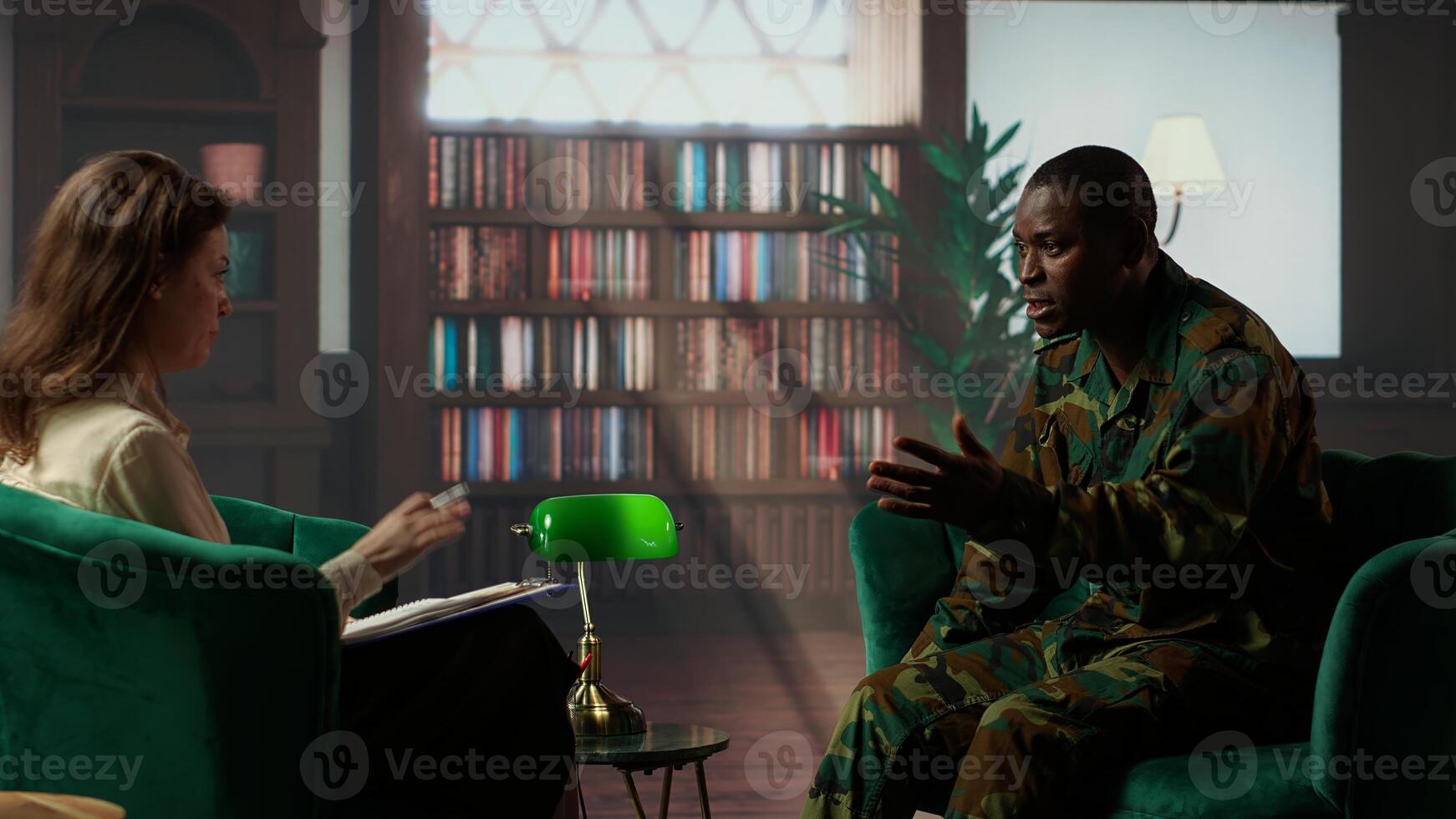 Military war veteran is in a vulnerable state opening up about combat horror scenes, crying and feeling frustrated after losing troopers. Serviceman discussing about traumatic experiences. Camera B. photo