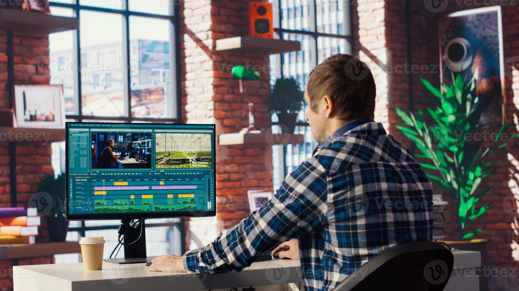 Remotely working videographer doing montage using specialized software applications. editor using editing tools on PC to cut movie project footage in home office, camera B photo
