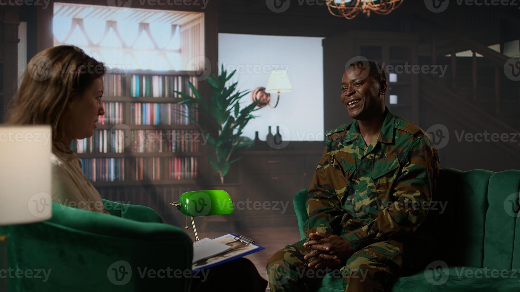 Black military officer in army uniform attends counseling session, looking distressed and opening up about post traumatic combat stress. War soldier dealing with shell shock. Camera A. photo