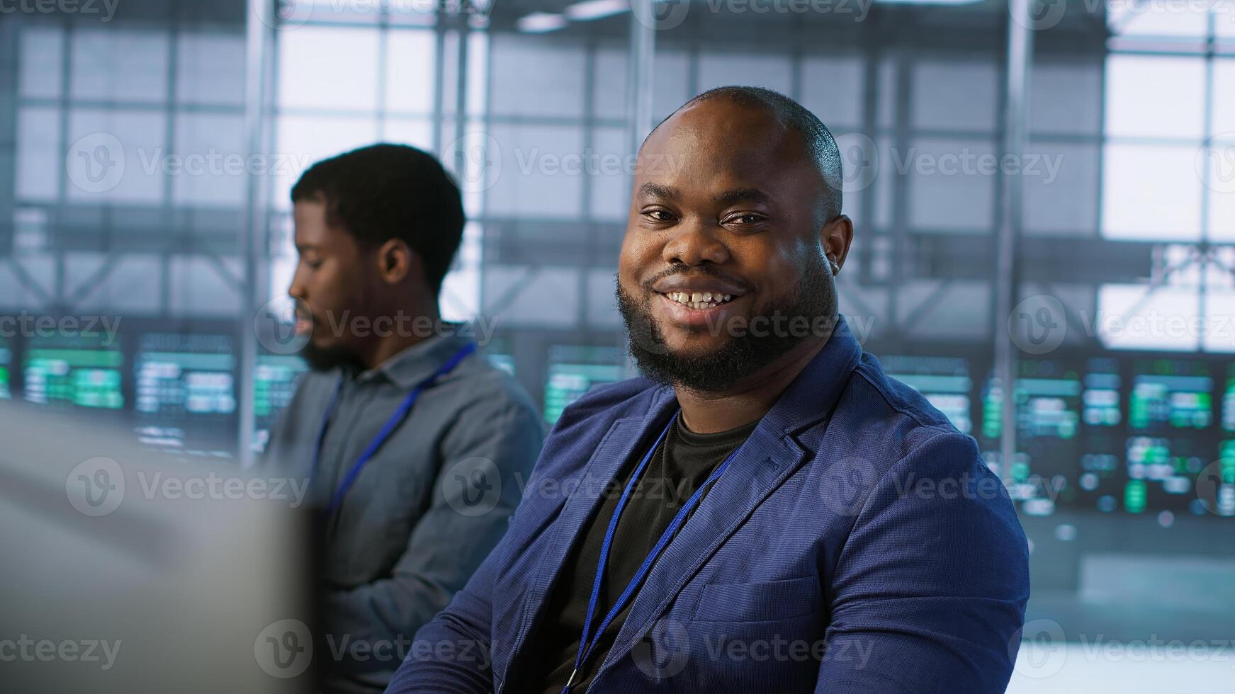 Portrait of happy server room worker developing disaster recovery plans ensuring minimal downtime. Smiling technician in data center using data analytics to monitor performance, camera A photo