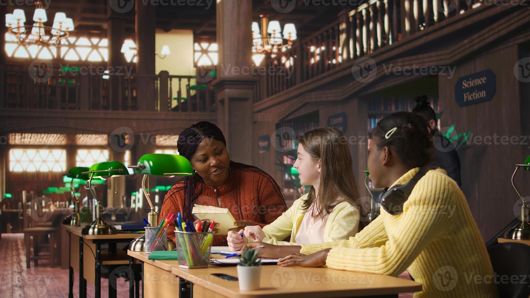 Teacher assisting scholars with class homework for mentoring session, providing academic instruction and support to help with the curriculum. Tutor lecturer gives private lessons. Camera A. photo
