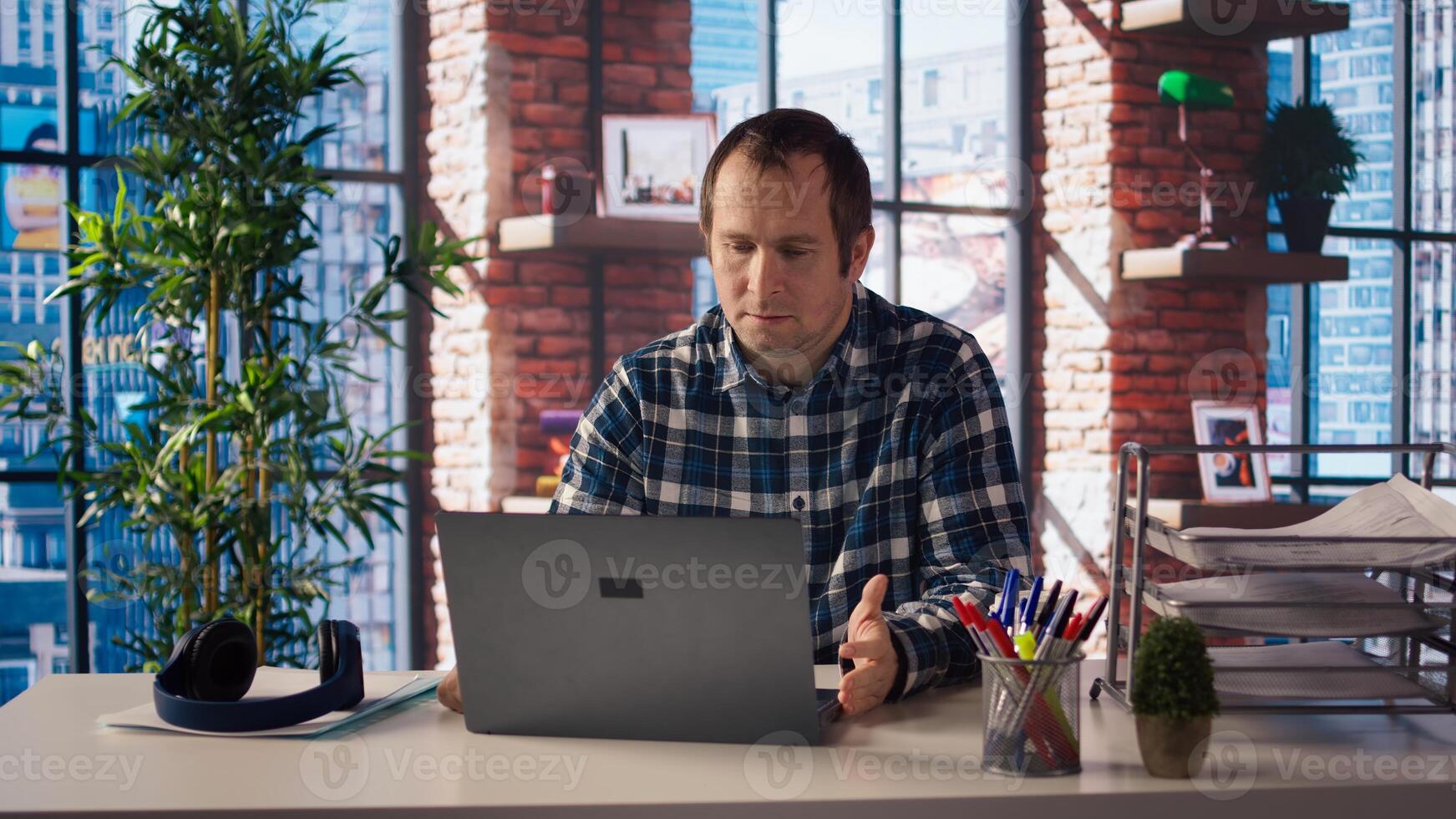 Remote employee calls managers remotely using internet videocall to ask for feedback on project progress. Teleworker at home requesting assistance from coworkers in teleconference meeting, camera A photo