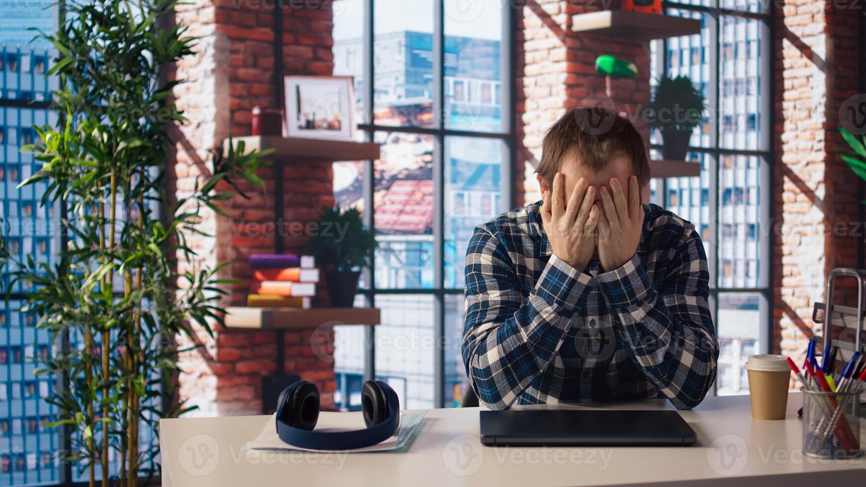Manager calls employee remotely using internet videocall to offer negative feedback on project progress. Angry team leader berating teleworker at home in teleconference meeting, camera A photo
