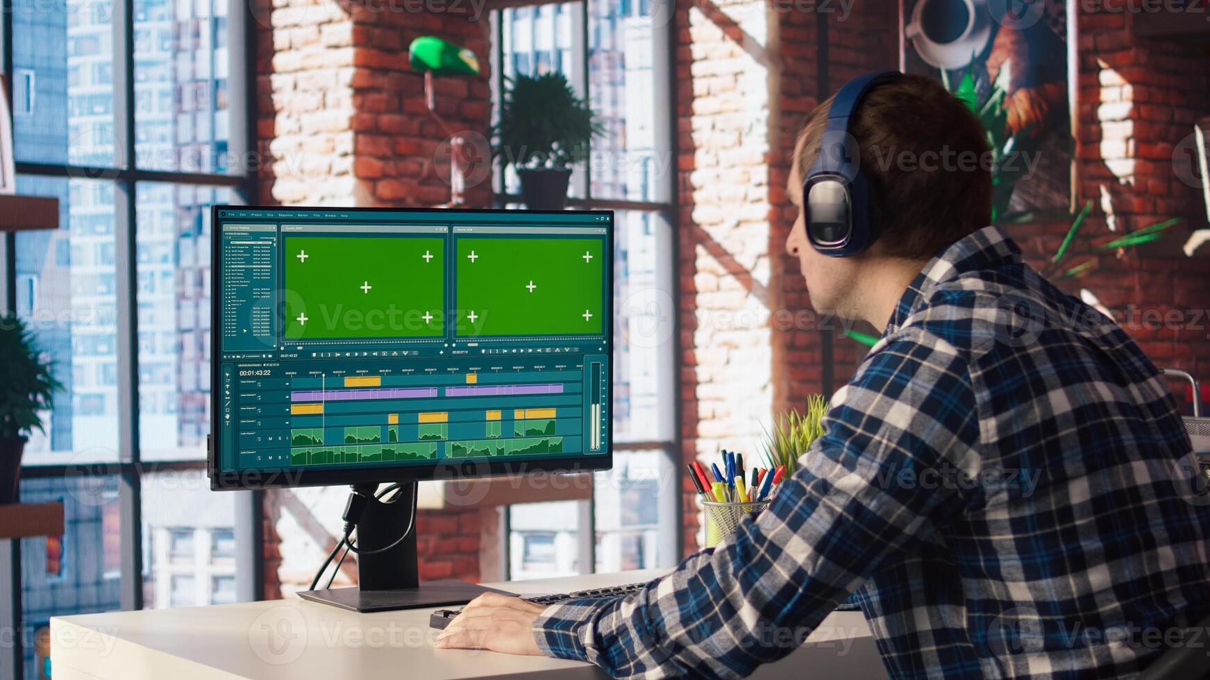 Remotely working videographer doing montage using specialized software application on green screen PC. editor using editing tools on mockup computer to cut movie project footage, camera A photo