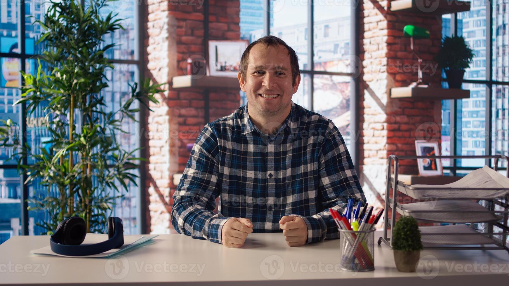 Manager in home office sitting at desk, filming onboarding for job candidates. Supervisor doing human relations job, recording answering inquiries from employees, camera A photo