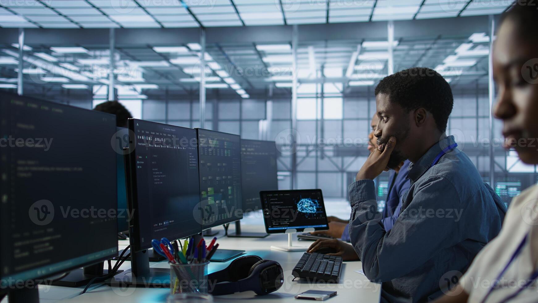 Cheerful server room workers laughing together in office while ensuring minimal downtime. Jolly engineers having fun in data center, using data analytics to monitor performance, camera A photo