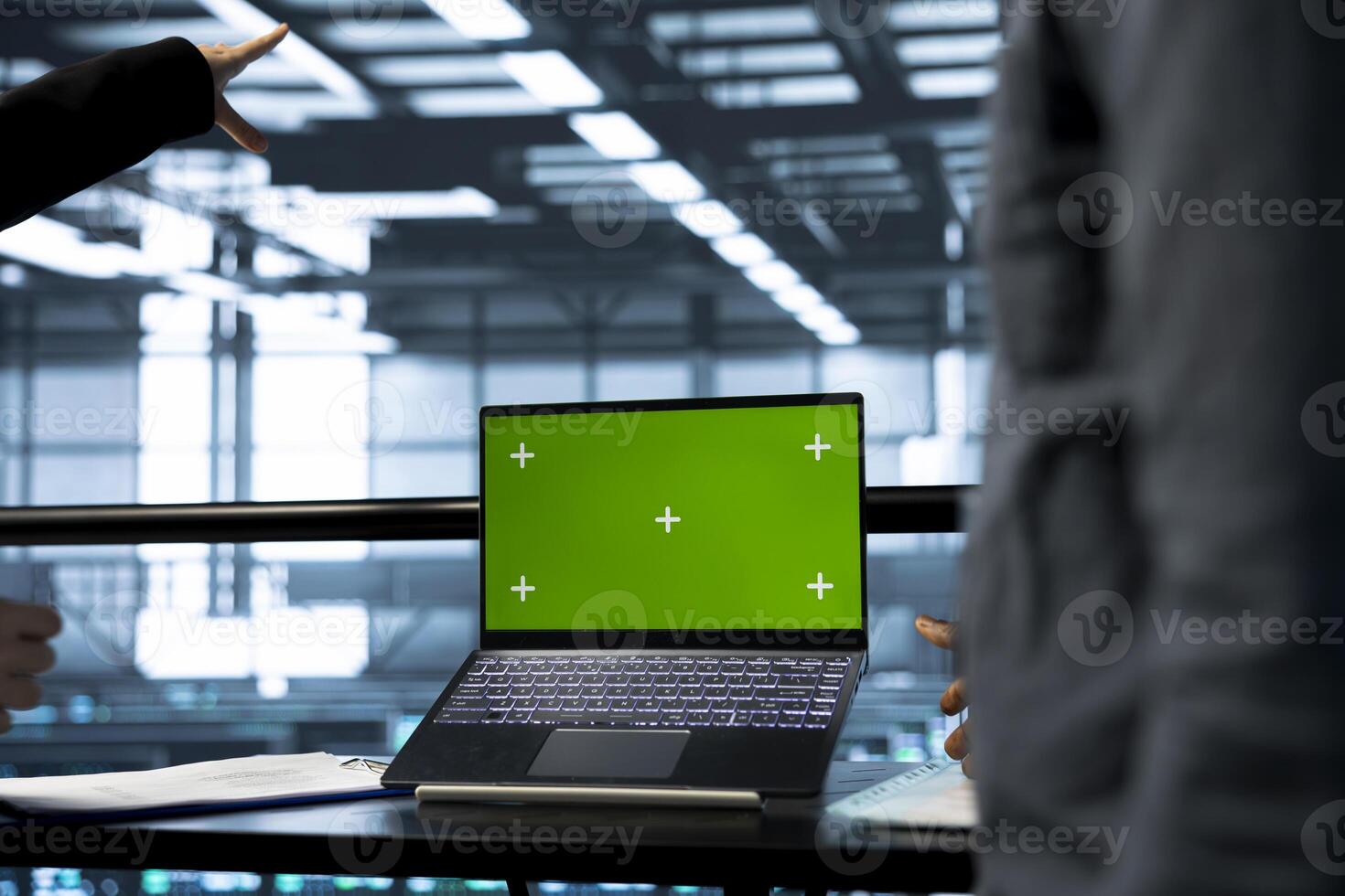System administrators in data center using green screen mockup notebook, observing analytics, reviewing equipment health. Server room employees using chroma key laptop, adjusting system parameters photo