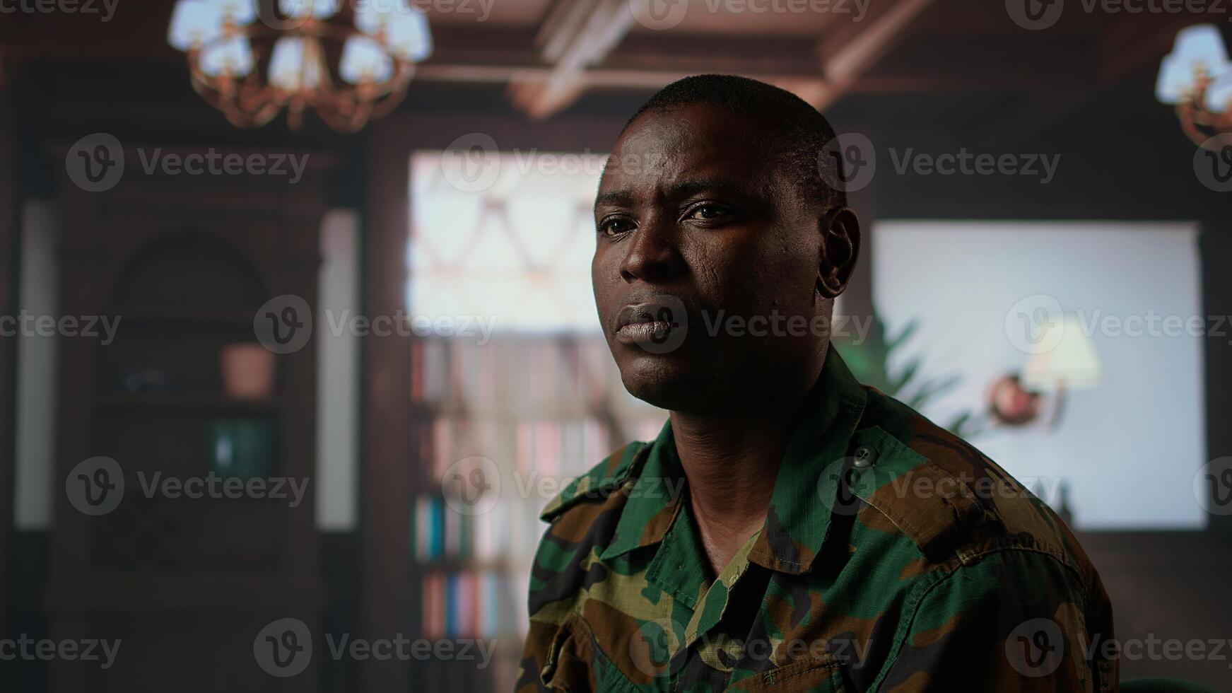 Armed forces trooper deals with depersonalization syndrome due to combat PTSD, feeling distressed and dissociative during therapy session. Black soldier with shell shock and trauma. Camera A. photo