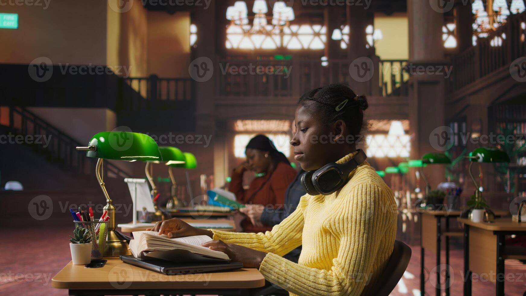 Professor at the library correcting teen schoolgirl with an incorrect posture, telling the student to straighten her back and prevent a backache. African american girl with a bad pose. Camera A. photo