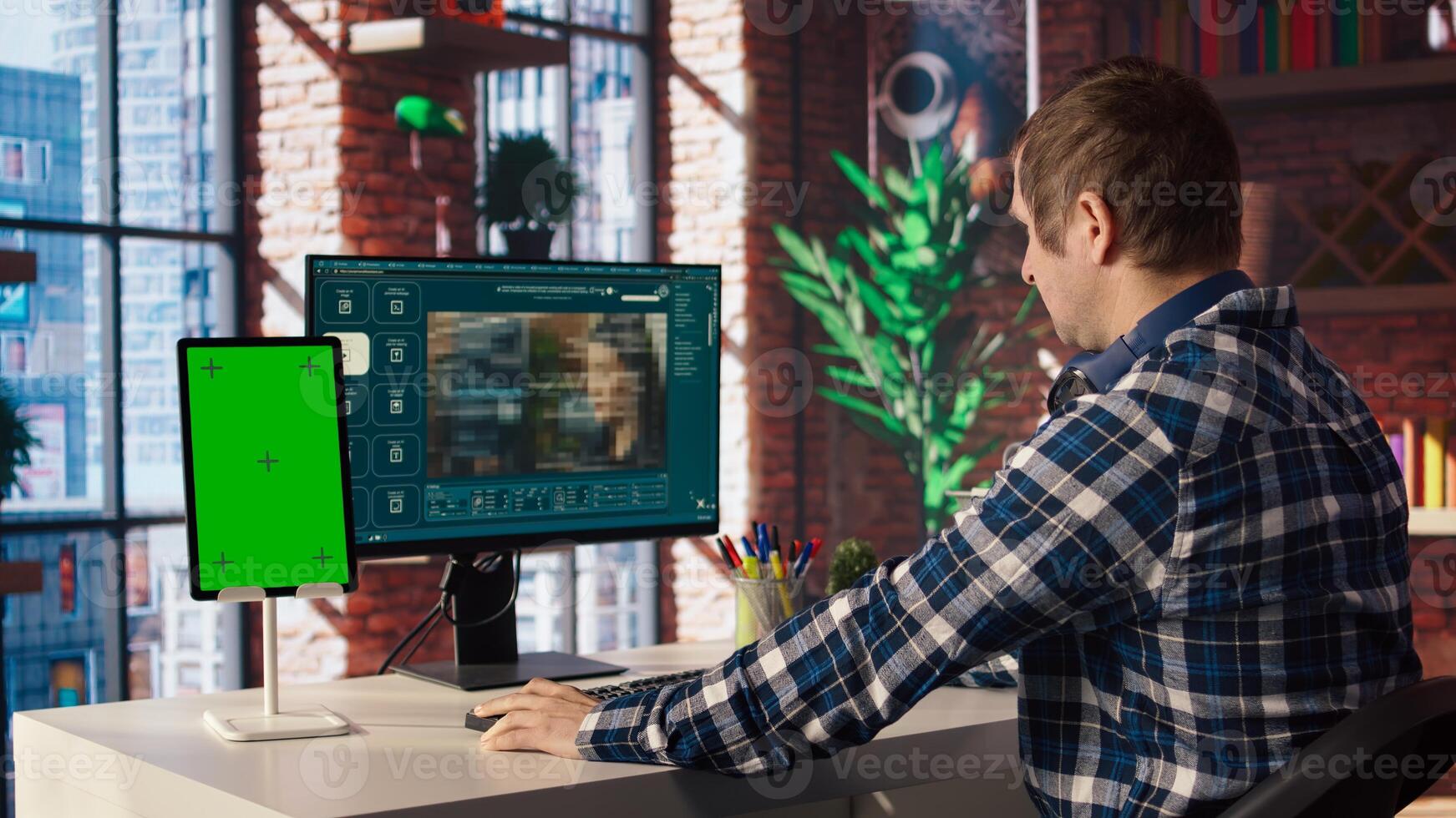 Man watching guide on mockup device about generative artificial intelligence generating videos. Man looks at tutorial on green screen tablet about AI virtual assistant producing clips, camera A photo