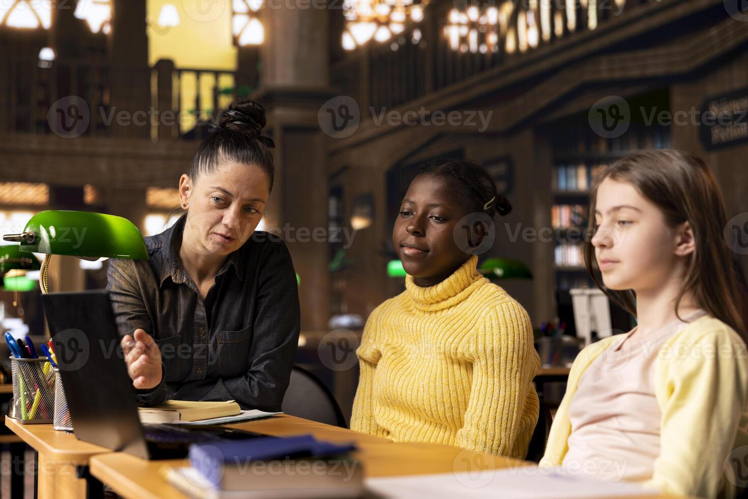 Academic mentor guiding young learners through schoolwork and assignments, emphasizing diverse teaching methods and effective communication. Professor tutoring her pupils after class. photo
