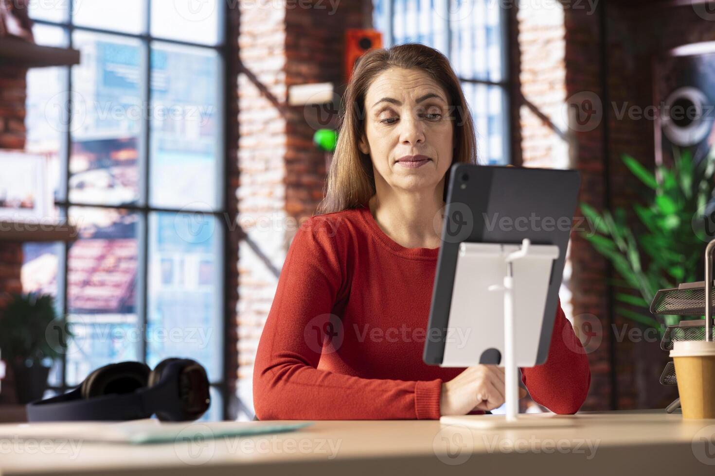 Female remote worker smiling during a virtual meeting with her trainer, showcasing the effectiveness of online tools and internet connection. Woman starting her training session for the new job. photo