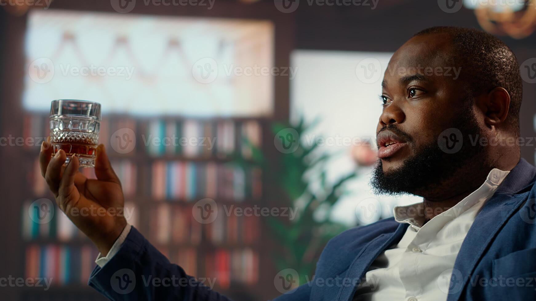 Multiethnic entrepreneurs talk business strategy over whiskey in a luxurious social club, capturing the essence of upper class entertainment and professionalism. High society members. Camera B. photo