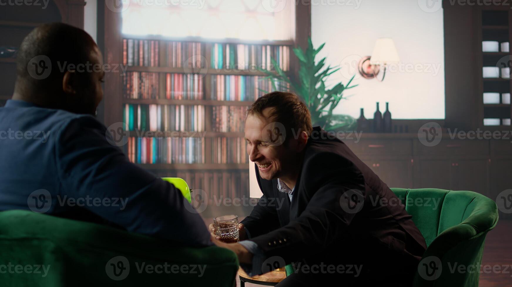 Drunk upper class elite society member being loud and obnoxious at the social club, embarrassing himself due to alcohol intoxication. Gentlemen in a state of euphoria after whiskey drinks. Camera A. photo