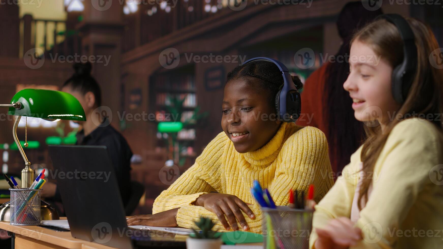 Students preparing for lecture and writing ideas next to copy space screen in textbooks at a study desk, creating a reflective essay as homework in the library. School work. Camera A. photo