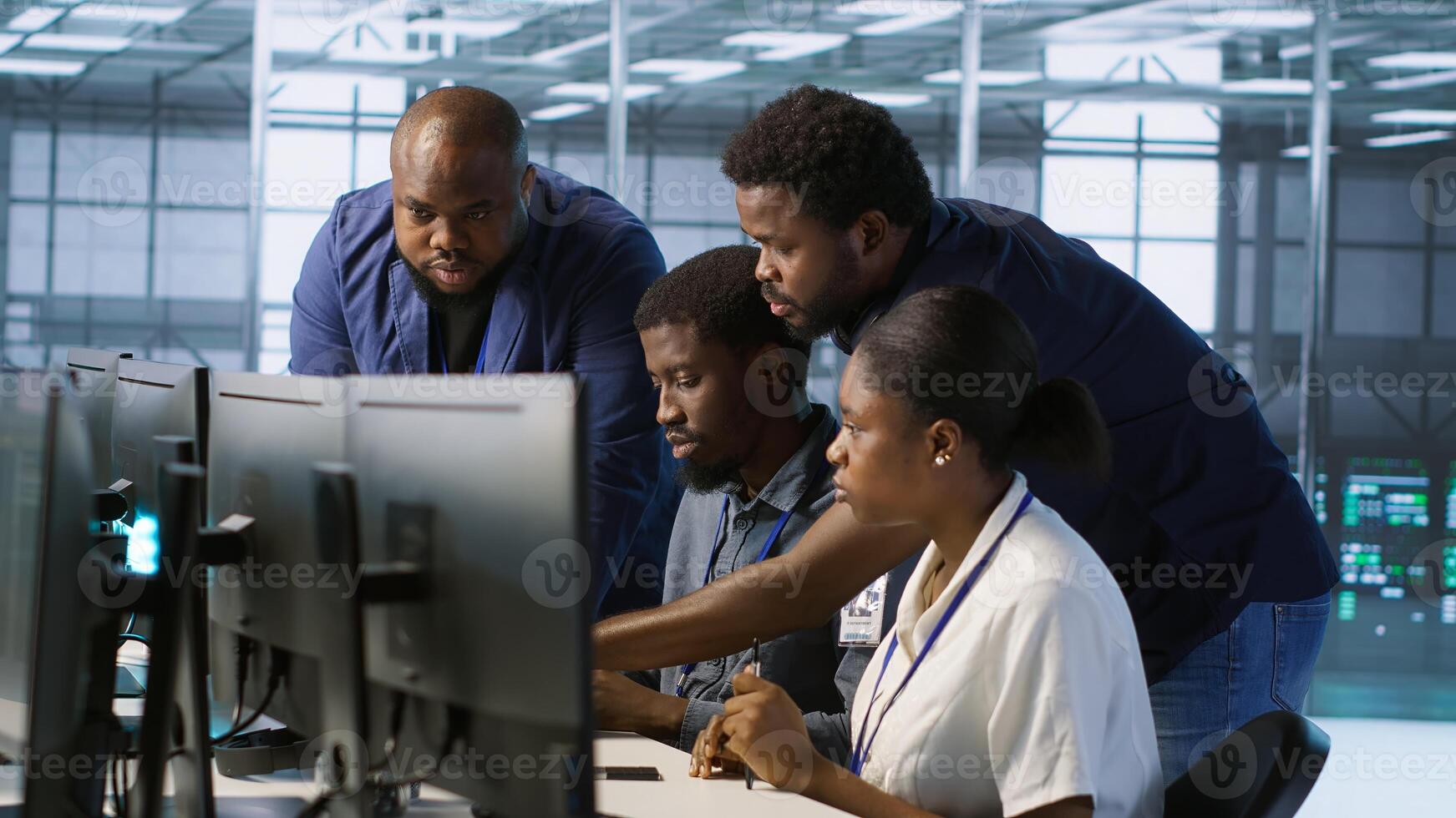 Teamworking engineers talking in server room, developing disaster recovery plans ensuring minimal downtime. Team of data center employees doing brainstorming, monitoring performance, camera A photo