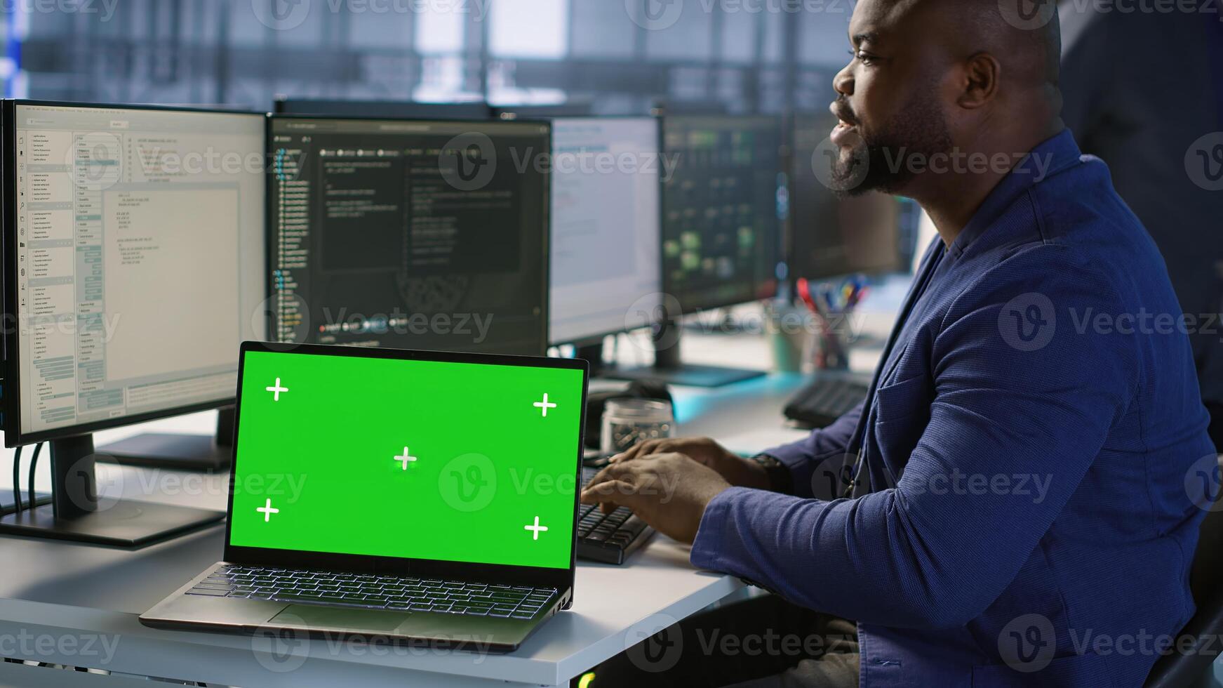 Data center technician using chroma key laptop, maintaining company network infrastructure. Server hub employee ensuring optimal system performance with isolated screen notebook, camera A photo