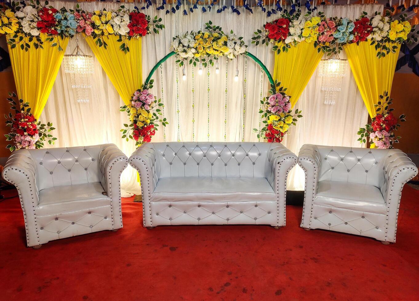 Elegant indoor seating arrangement with floral decorations at an event space showcasing luxury furnishings and vibrant colors for a memorable occasion photo