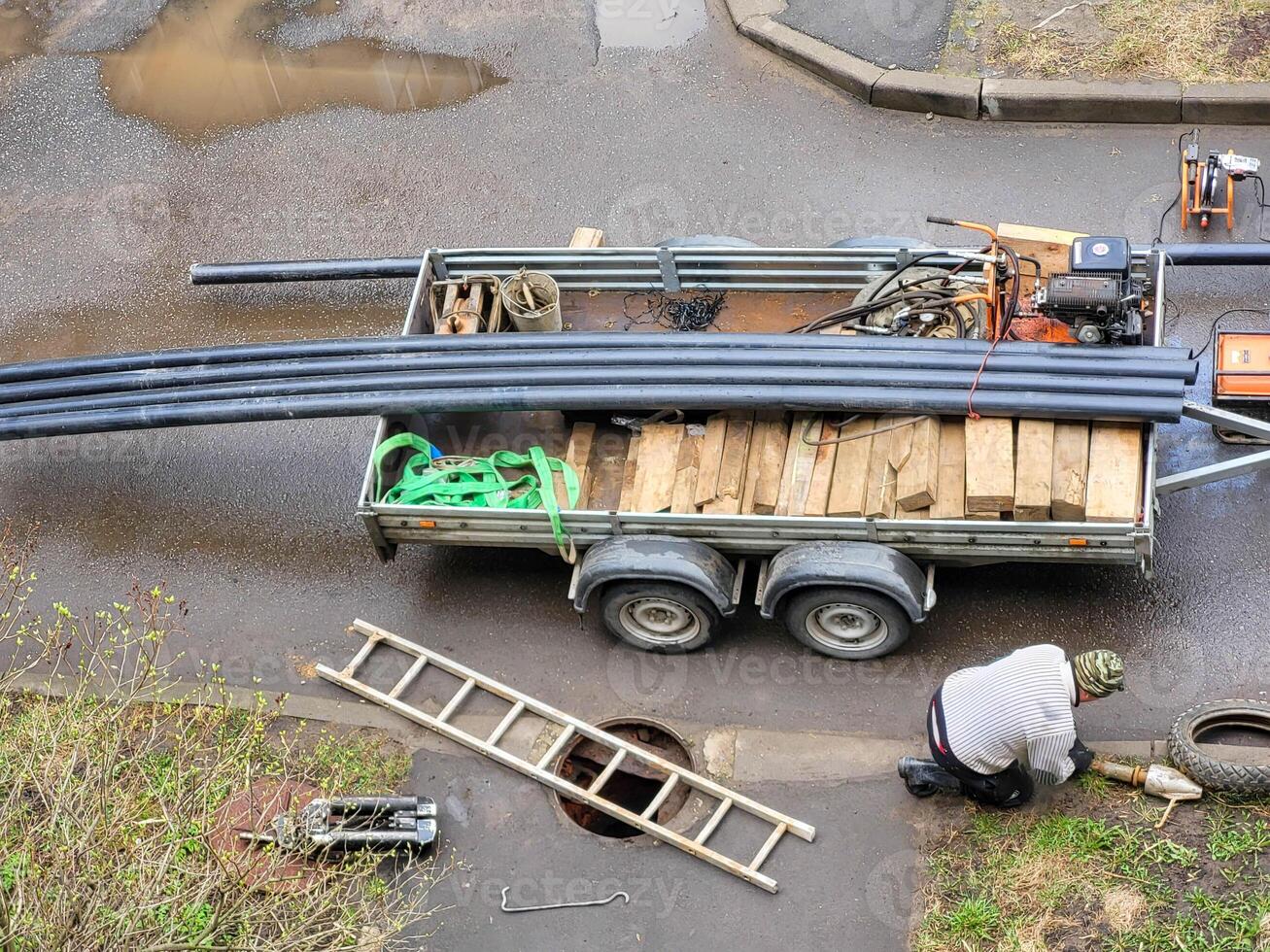 Plastic water pipes lie in the back of a truck top view from the window. photo